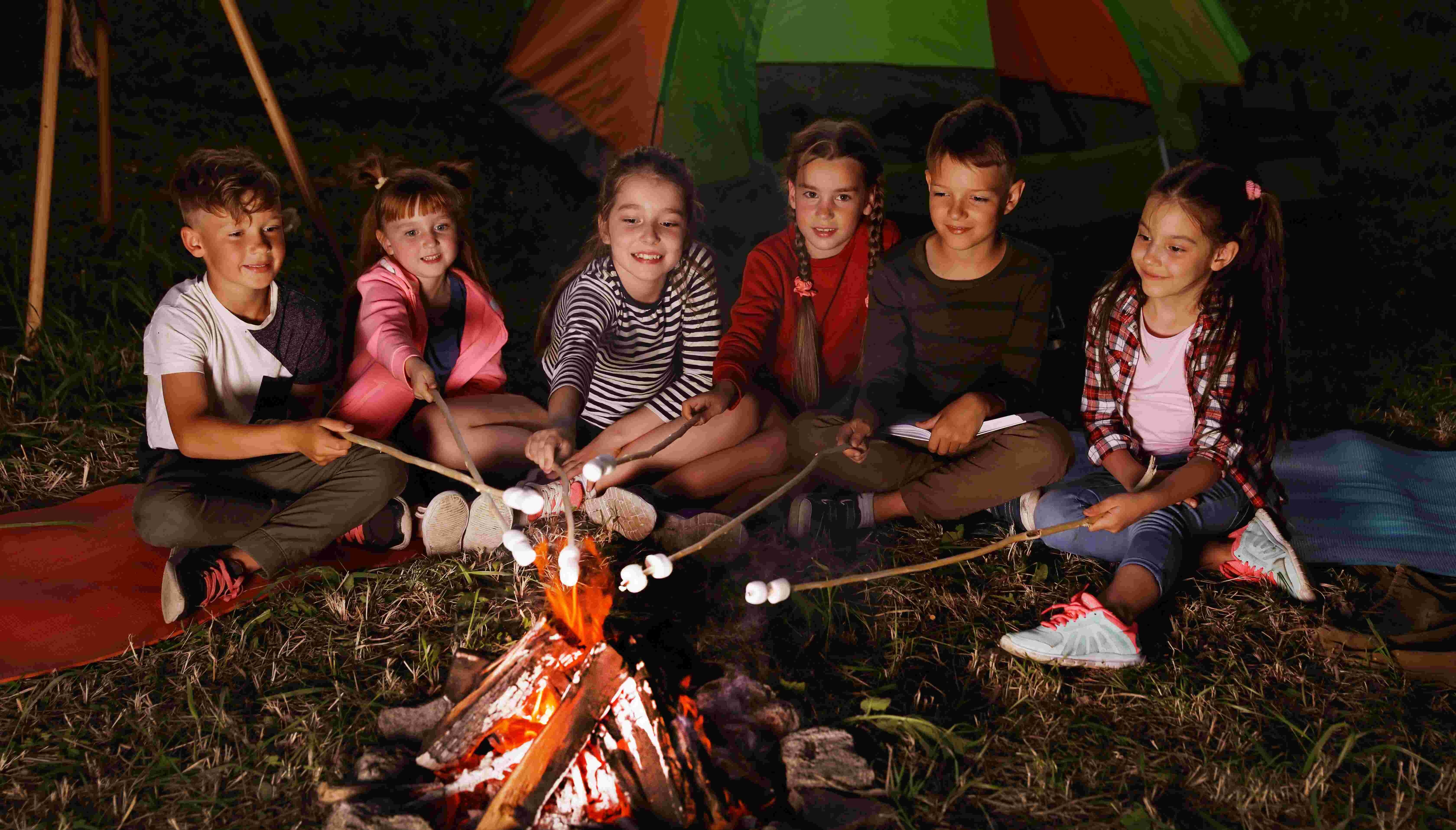 kids making smores at campfire